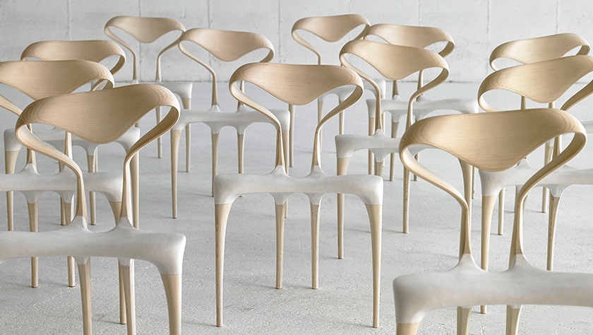 group of armless sculptural dining chairs in bleached ash