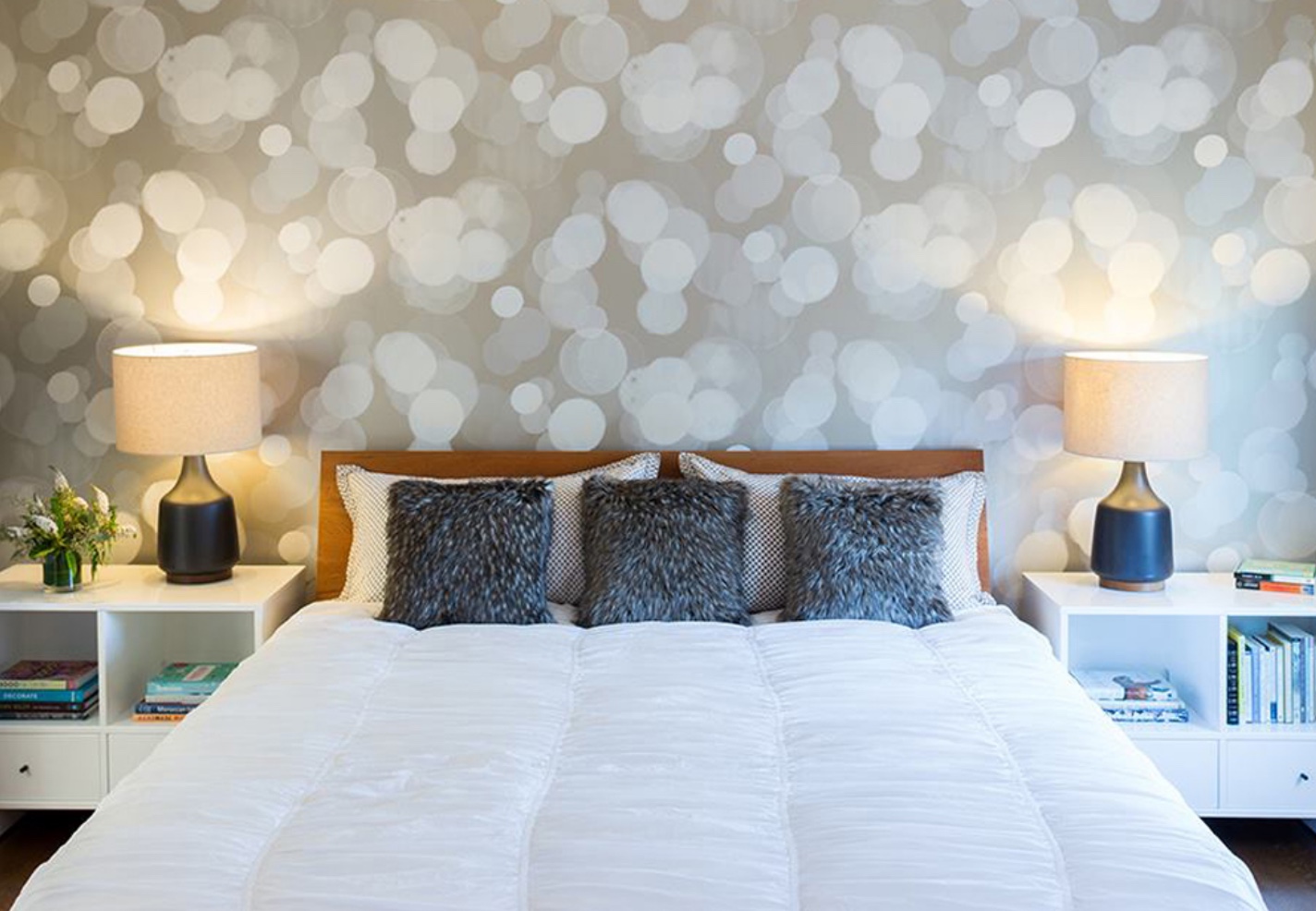 bedroom with wallpaper on wall featuring gray and white haloed lights