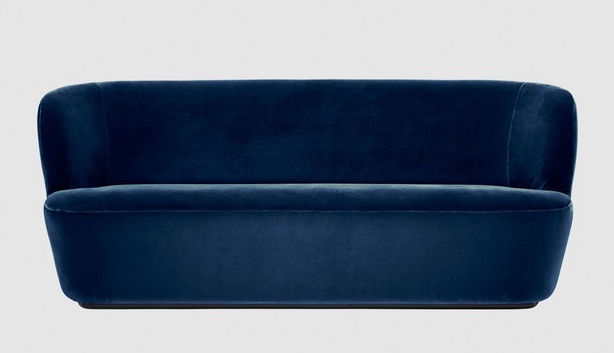 simple organic upholstered sofa in dark blue velvet