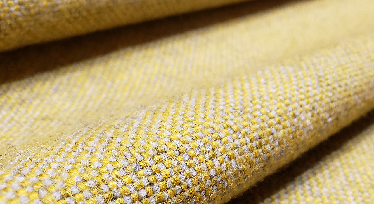 detail view of 100% wool textile in yellow
