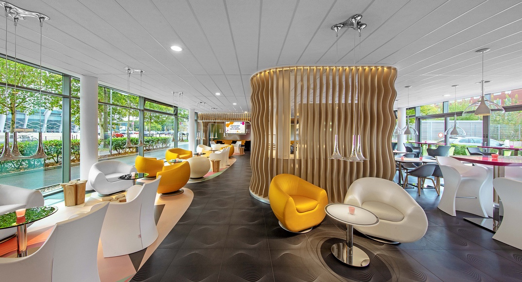 modern hotel lobby with curvy chairs and wood slat walls