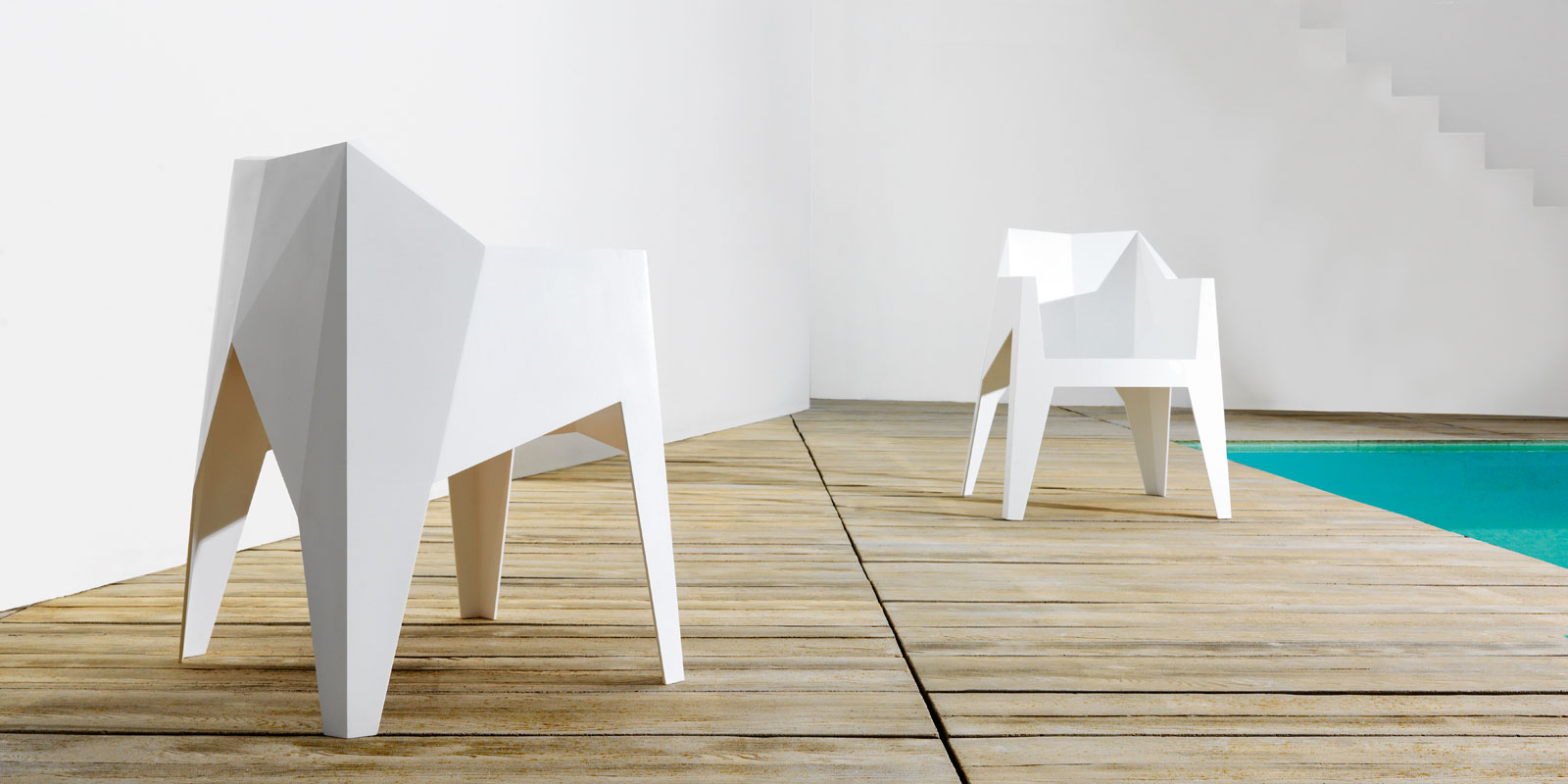 white poly armchair on wooden deck
