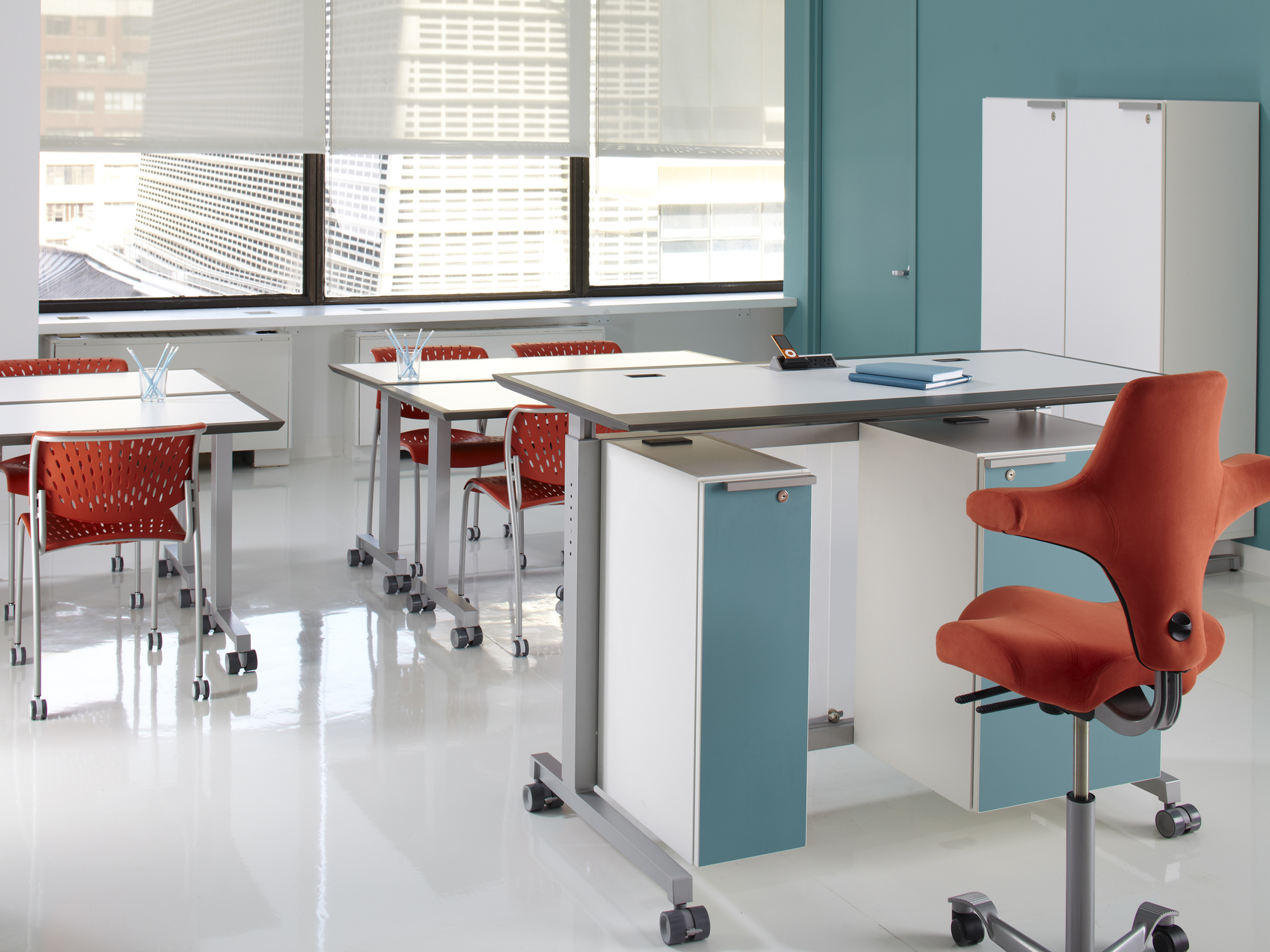 Dewey by SurfaceWorks teacher's desk and several rectangular desks in classroom setting