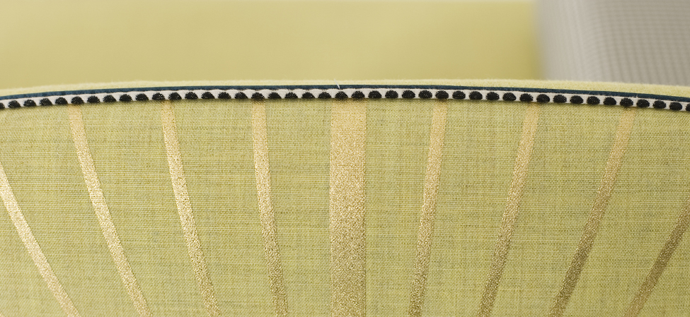 detail of upholstered sofa with gold thread