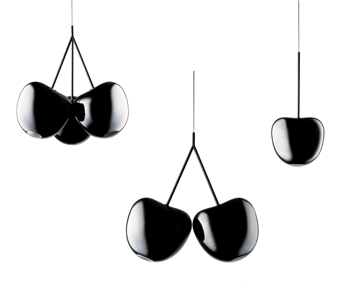 group of glossy black pendant lamps shaped like cherries