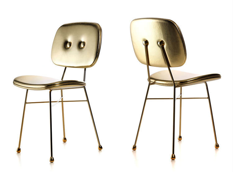 two gold dining chairs with glossy finish