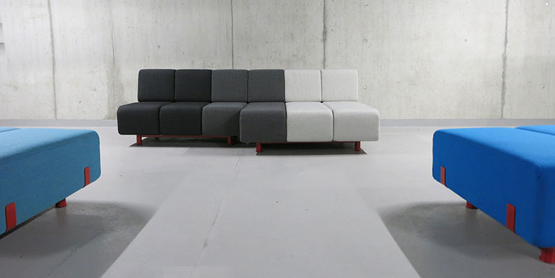 Werner Aisslinger design Pin Sofa in black, grey, and white with partial views of sofa in blue