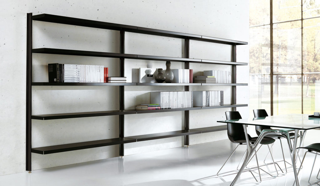 white minimalist room with black metal shelving unit and glass dining table