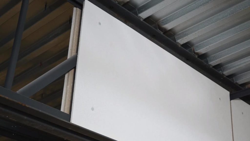 Armstrong Ceiling and Wall Solutions' Invisacoustics white panels mounted to i-beam