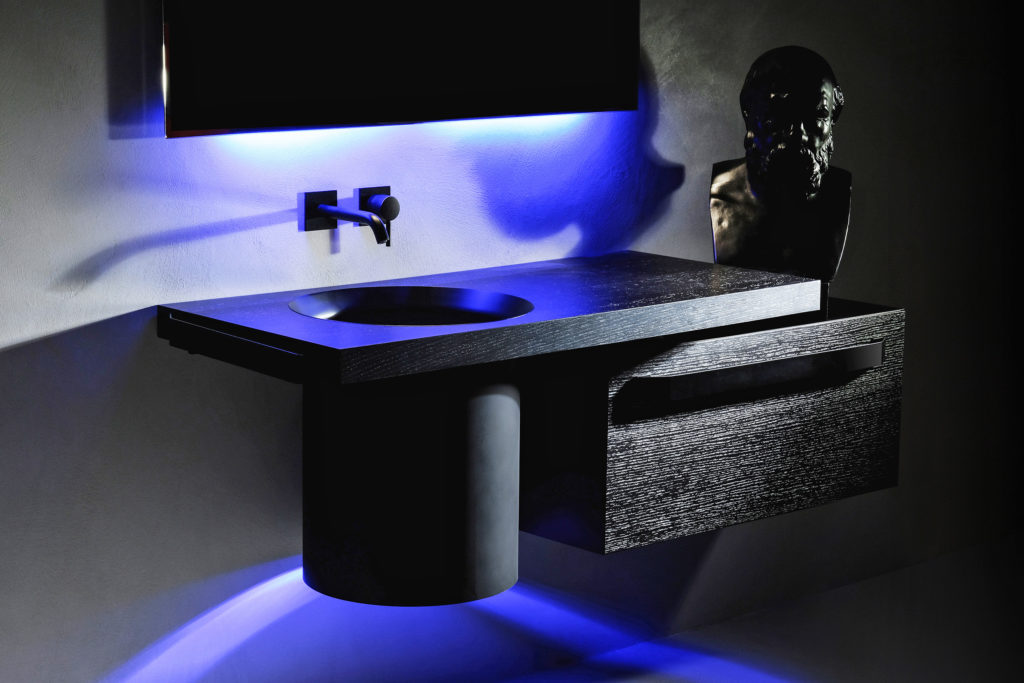 Atelier 12's Abisso Bathroom recessed basin in black lacquer vanity with blue pedestal lighting