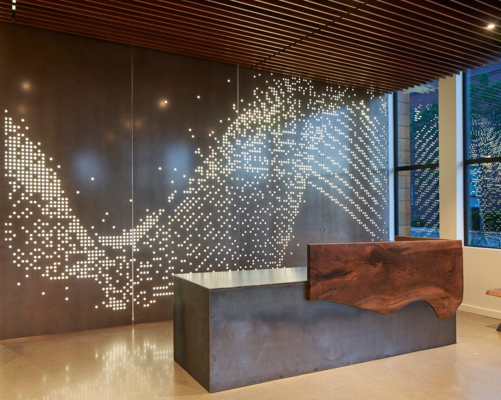 Móz Backlit Metal Solutions illuminated panel with wave effect in hotel lobby