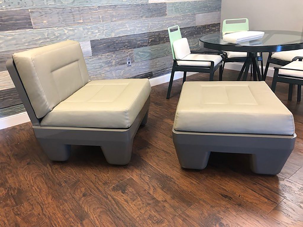 Benchmark Contract Furniture chair and ottoman with gray base and tan cushions