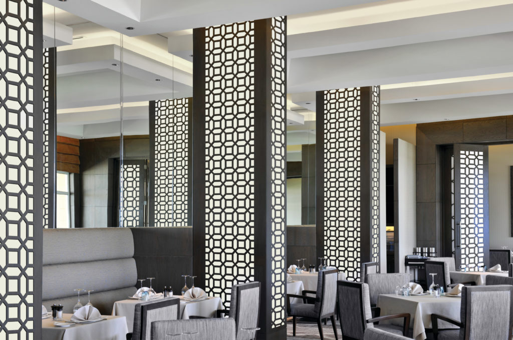 Móz Backlit Metal Solutions illuminated columns in black and white art deco pattern in restaurant