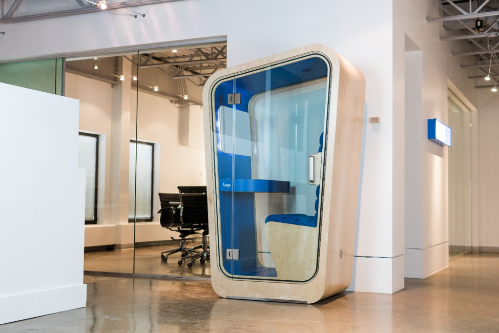 Loop Phone Booths Solo with blue upholstery and whiteboard in open office