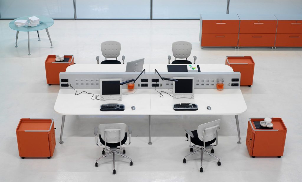Claudio Bellini TW Frezza work system with conjoined desking and task chairs in white with surrounding orange mobile storage and a light blue table 