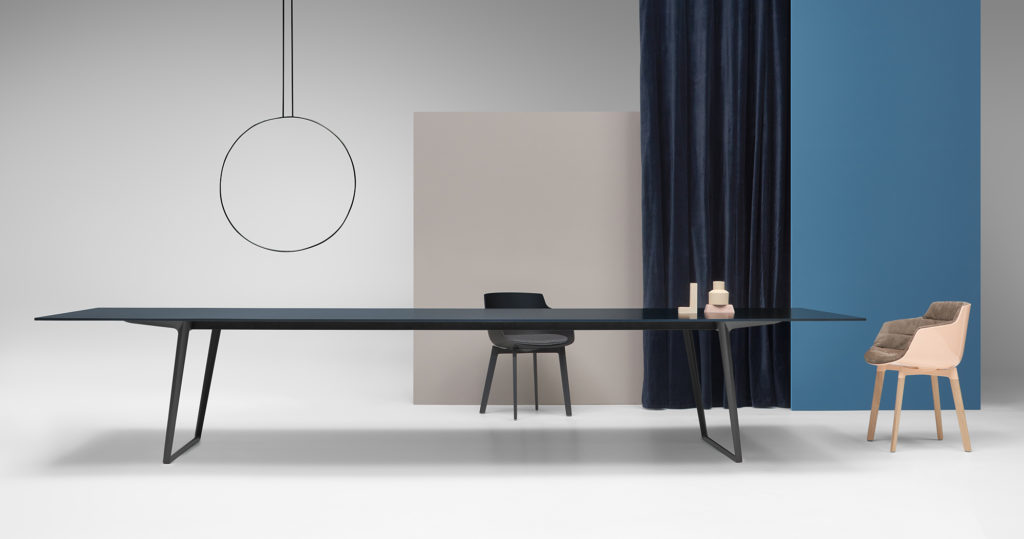 Claudio Bellini Axy Table in black very long table in white room with black curtains and two chairs