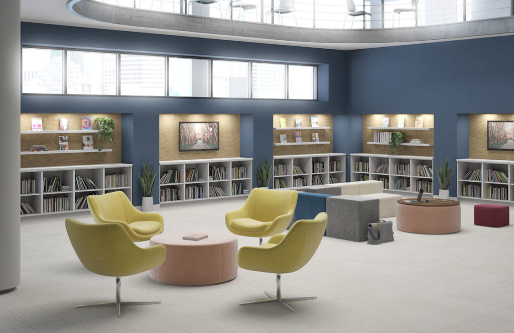 Alterna Casegoods in light-filled patient library white bookcases with yellow lounge chairs, pink ottomans, and modular sofa