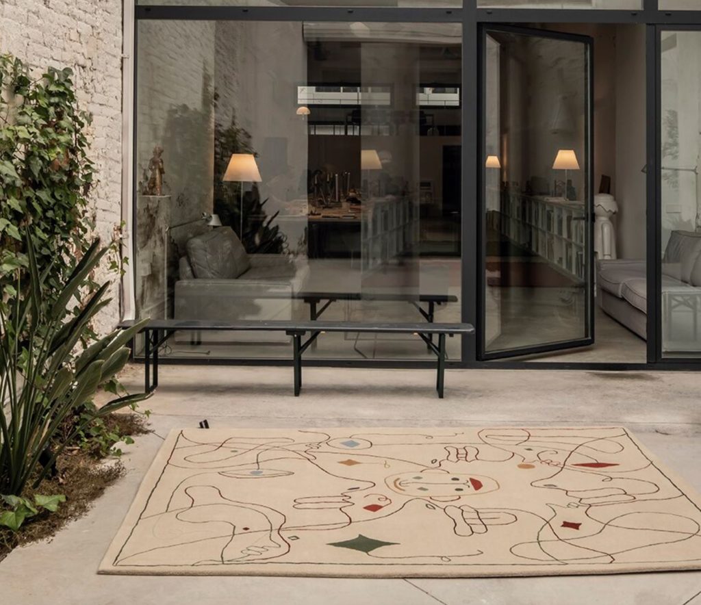 Nanimarquina Silhouette Rug in front of home with glass and steel walls and doors
