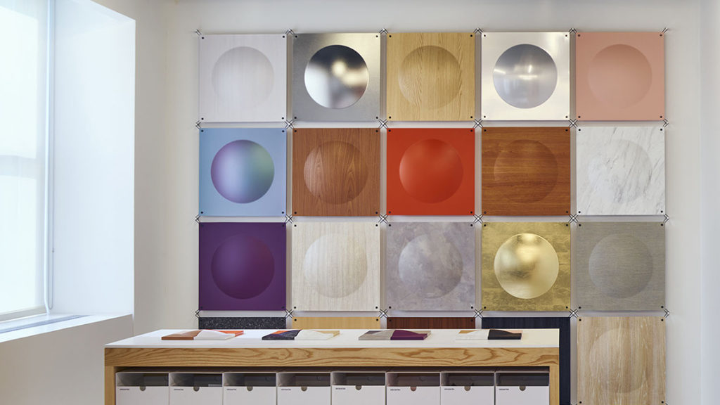 3M's DI-NOC Collection samples on wall in showroom. 15 samples including wood, metal, and solid colors