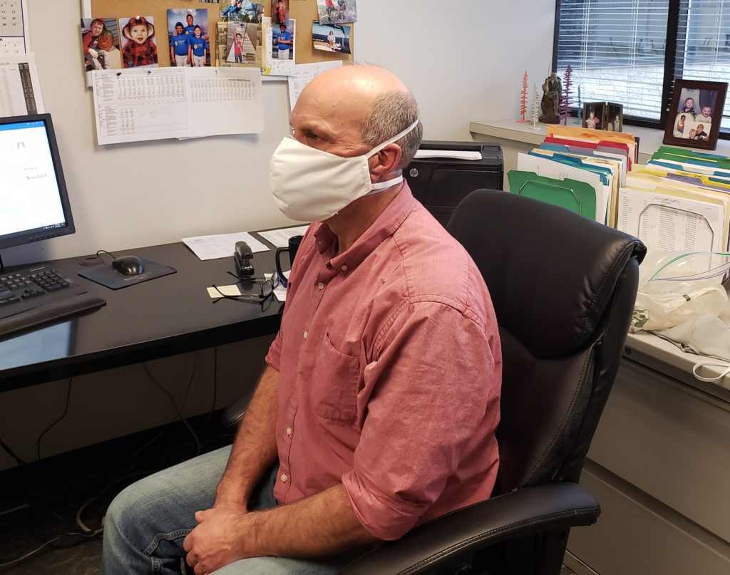 Coronavirus mask man wearing it in office