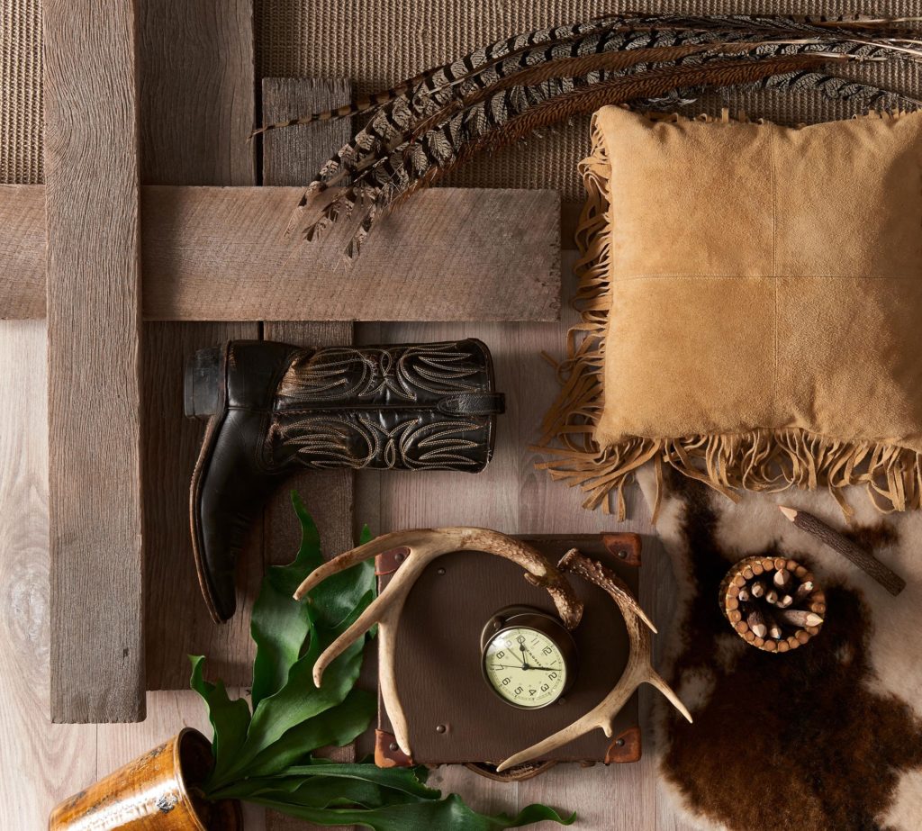 Faux Wood close up weathered plank decorative display with boot, old clock, antlers, and leather pillow