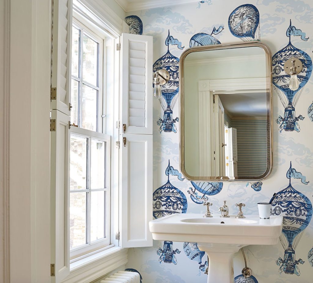Schumacher Flight of Fancy wallpaper Hot Air Balloons in bathroom with small mirror and sink near window