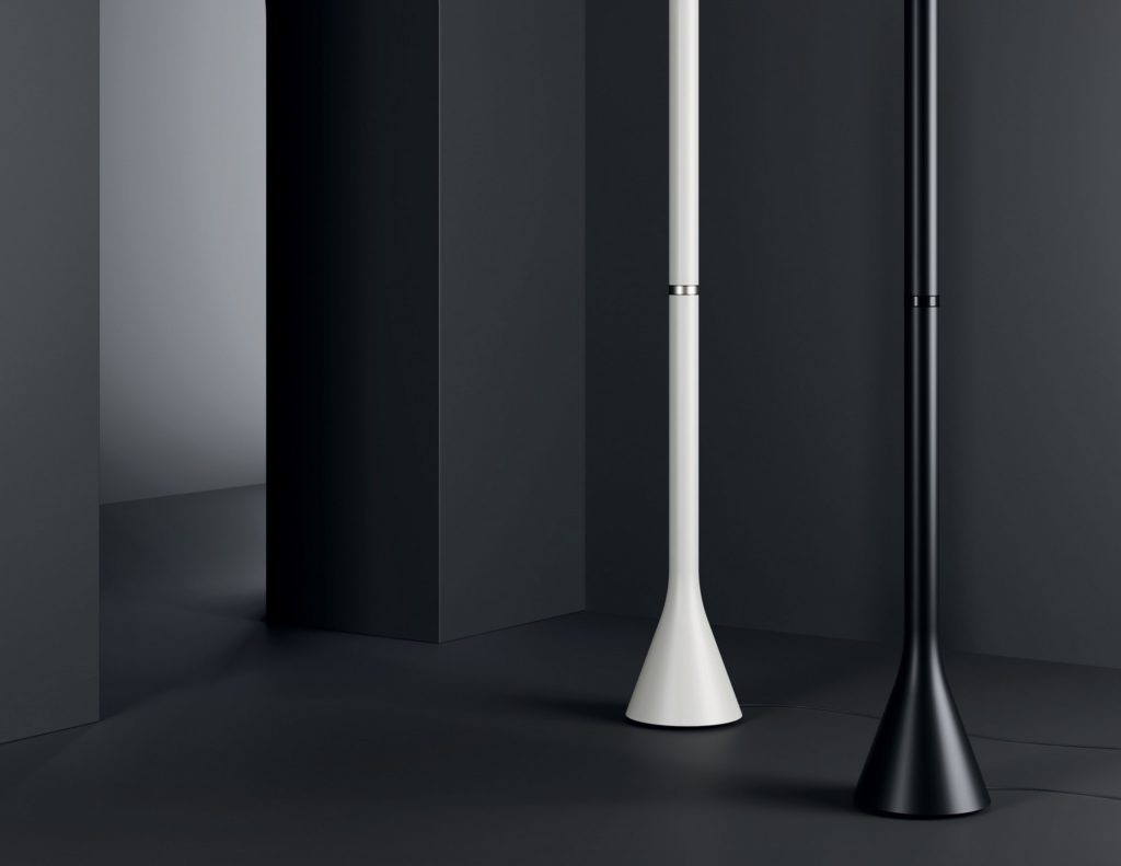Croma floor lamp one white one black in room with dark gray floors and walls