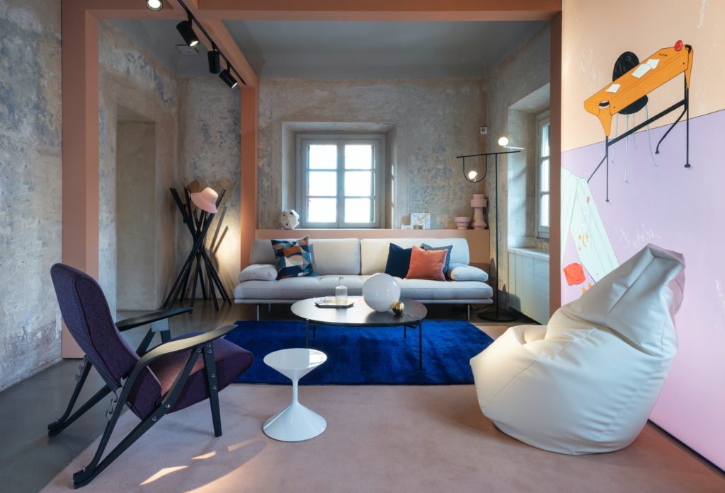 Intimacy Collection several pieces in interesting room with mural of furnitue, luminescent wallpaper, pink painted beams, and blue carpet