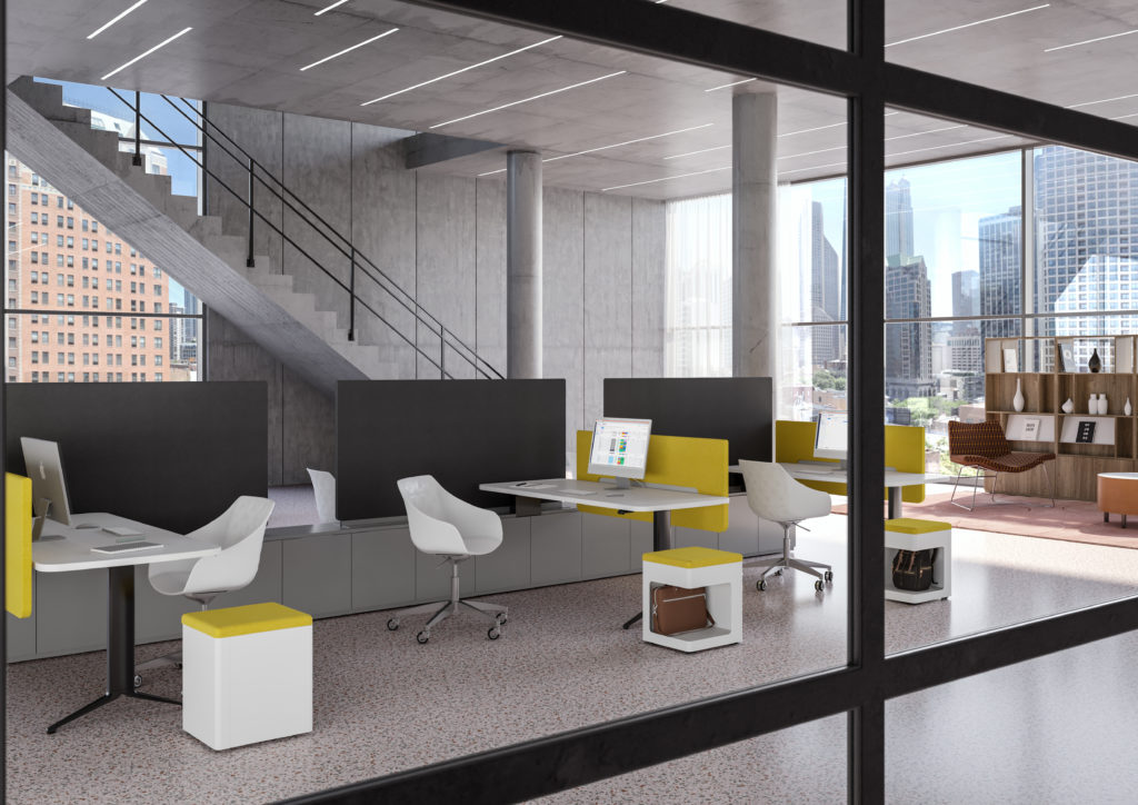EverySpace open workspace with desks with black base, white top, yellow screens, and white chairs next to dramatic open concrete staircase