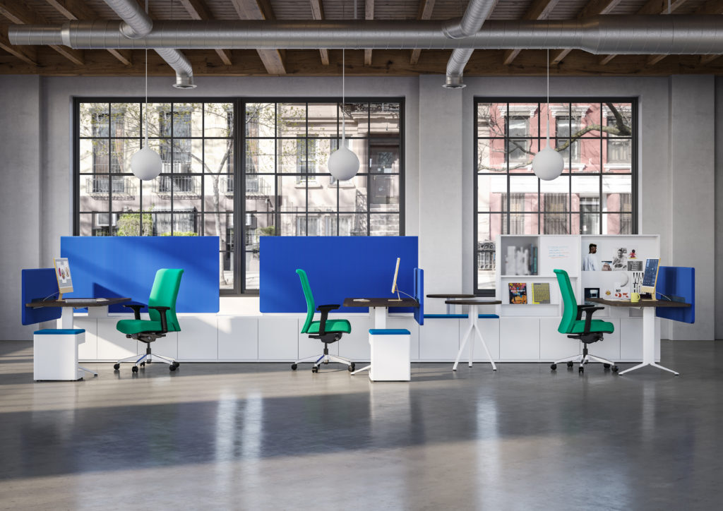 EverySpace open workspace with matching workstations in white base, wood tops, white pedestal storage, blue privacy screens, and green chairs with large windows looking out onto street scene