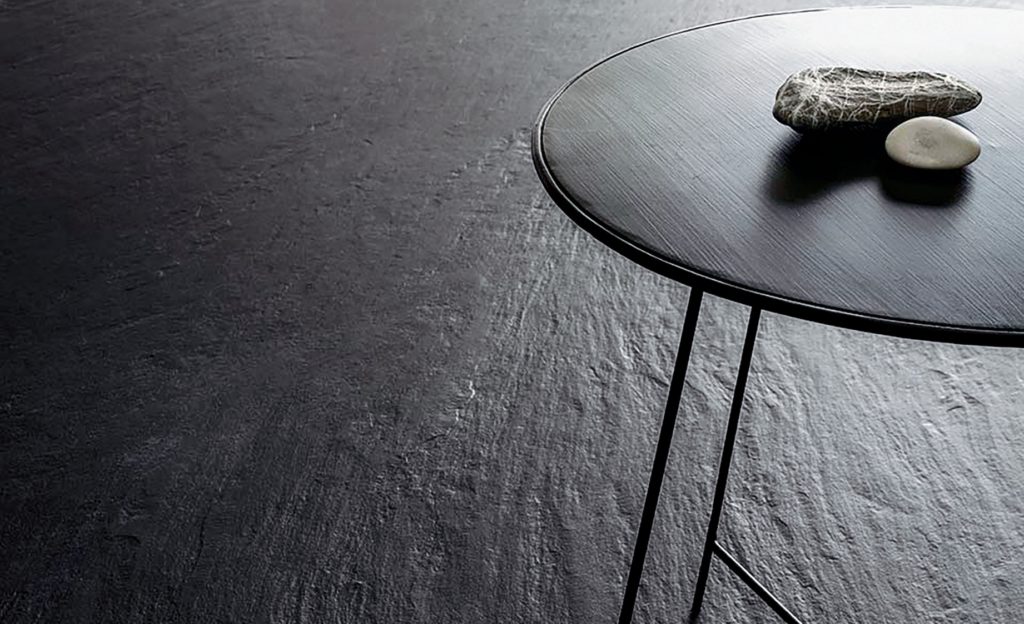 Ardesia a Spacco nero on floor with table 