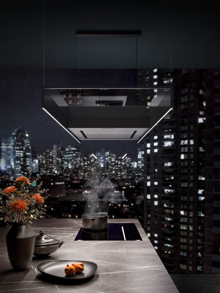 Falmec kitchen hood side view in fancy kitchen with city view out window