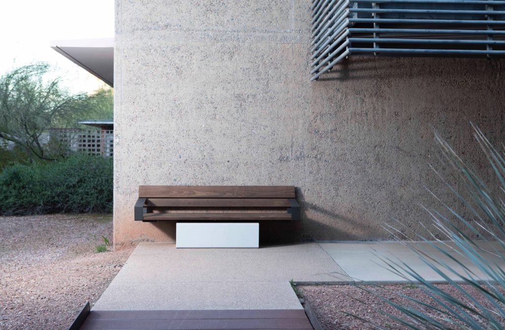 Link wall-mount single bench with concrete block base in desert landscape