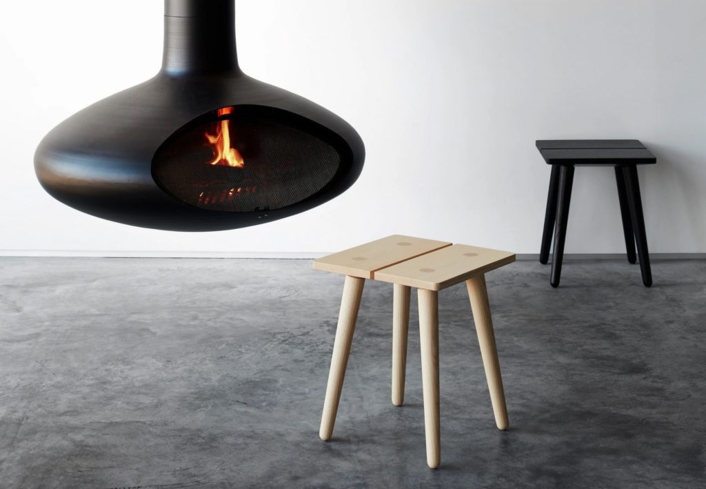Studio Seitz stool in natural near suspended wood-burning stove