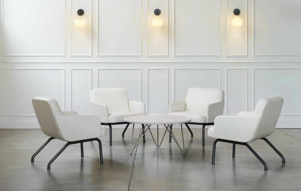 Nordic armchairs in white around small table