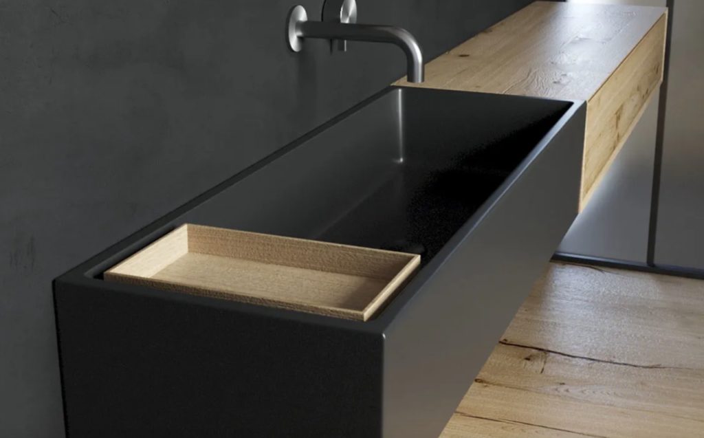 narrow black washbasin with natural wood countertop