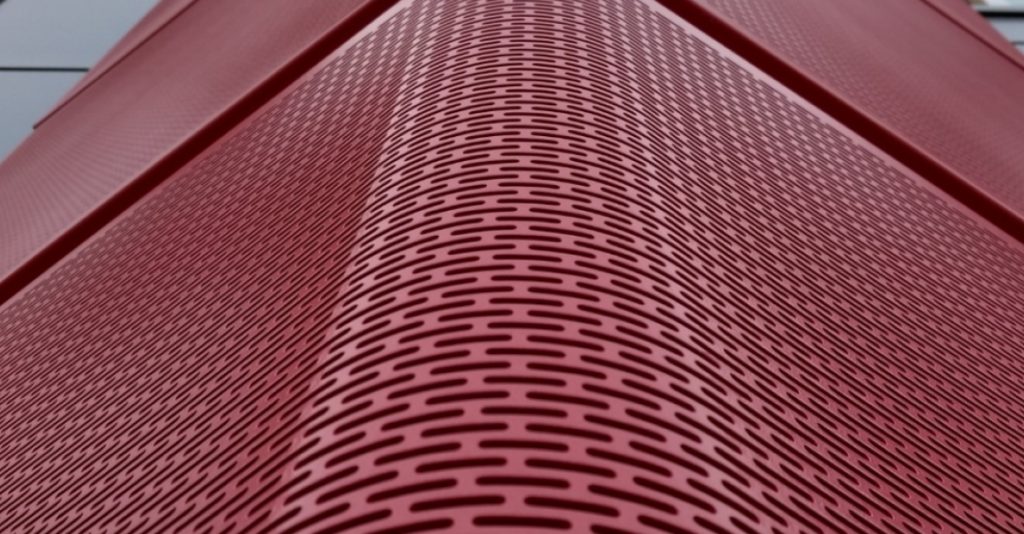 Accurate Perforating building facade in red