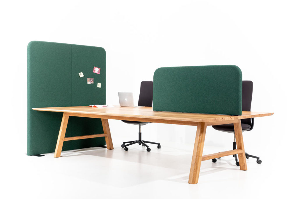 BuzziShield green partitions atop desk and floor to height with wood desk and chairs