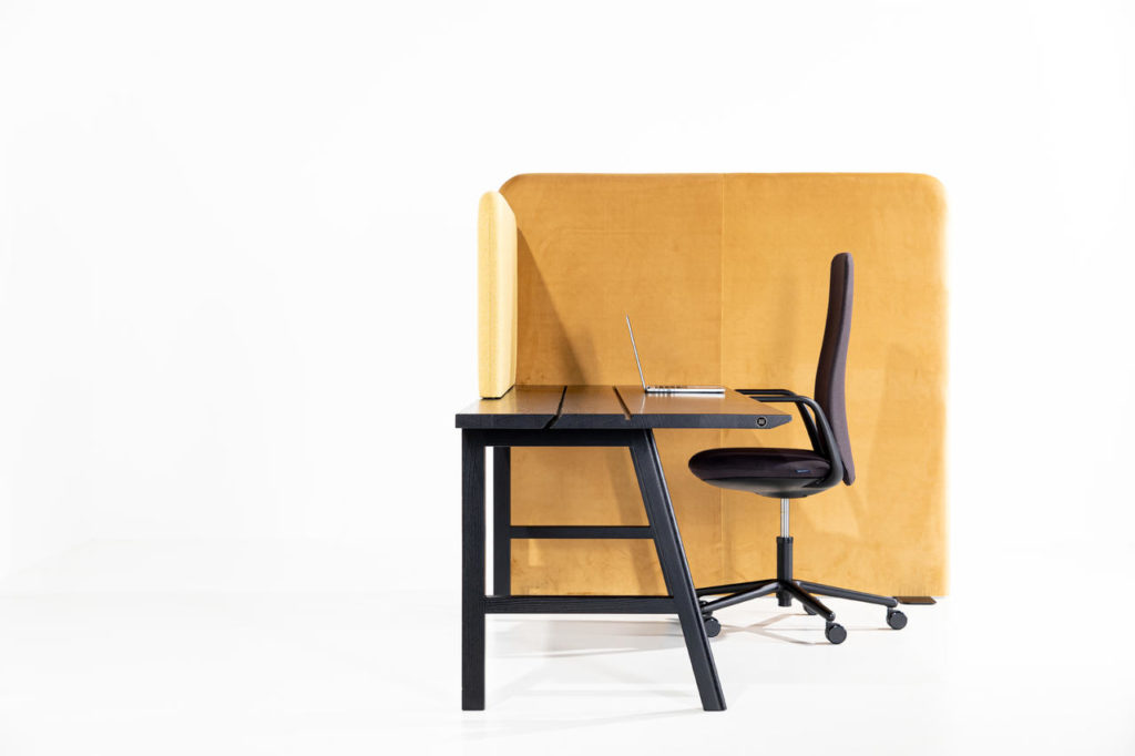 BuzziShield in beige floor to standing height and atop desk. Black desk with black chair. 