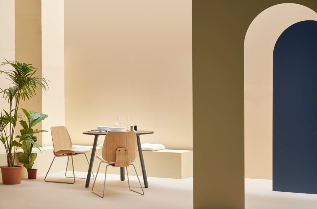 two chairs around circular café table in nice room with plants