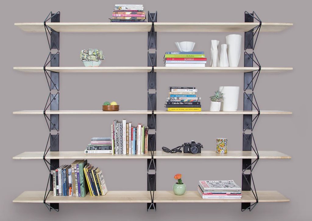Strut bookshelf on wall with combination of books and other decorative items