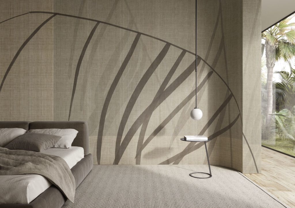 Abstract wallcovering with brownish/gray asynchronous lines on neutral backdrop with partial view of palm trees outside