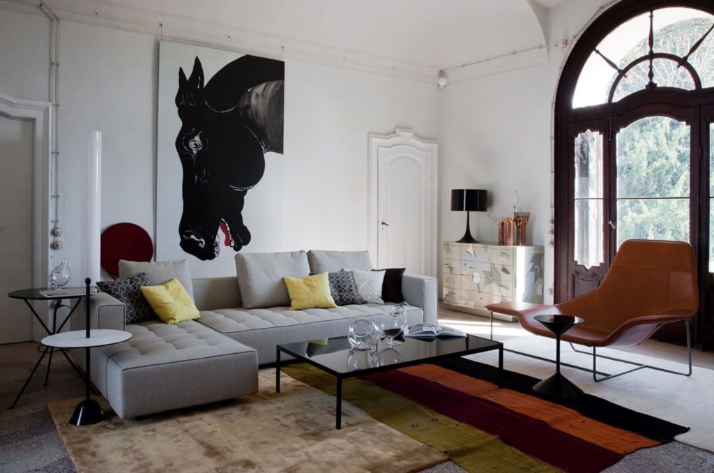 Leather lounge chair in fashionable living room with big horse painting