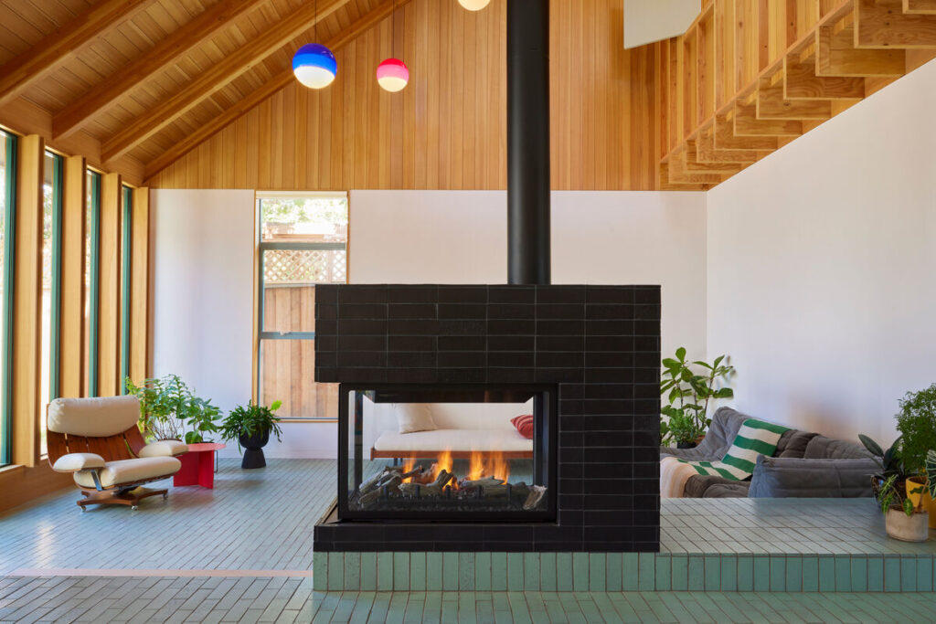 black horizontal tile surrounding open fireplace in midcentury modern home