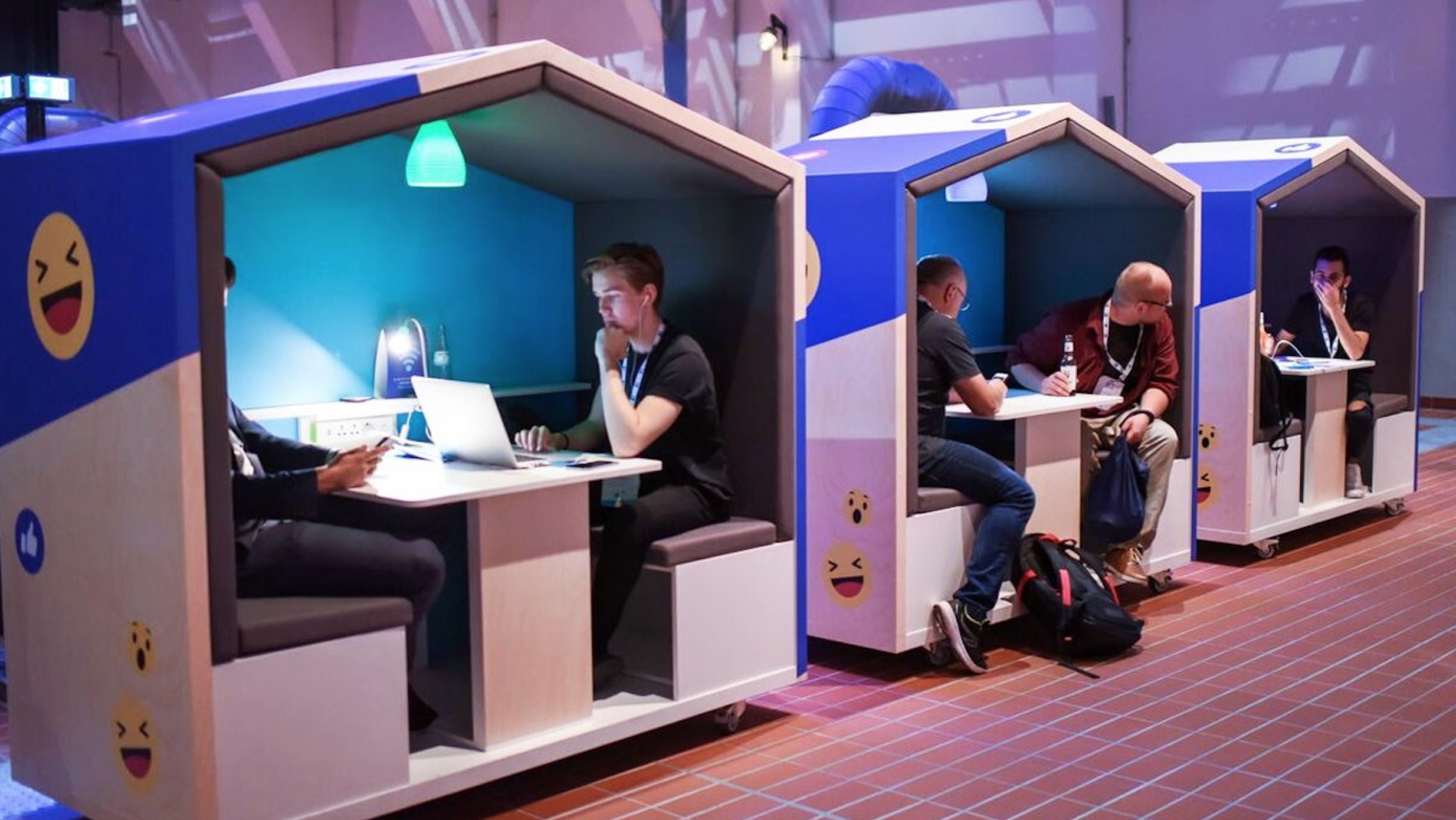 Three Nook Office Pods with Facebook branding (white and blue with smiley faces)
