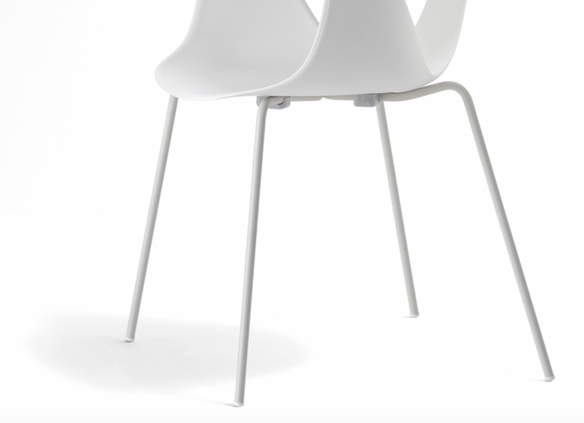 Image of the lower half of a Pedrali Fox Guest Chair in white with close-up on the steel legs