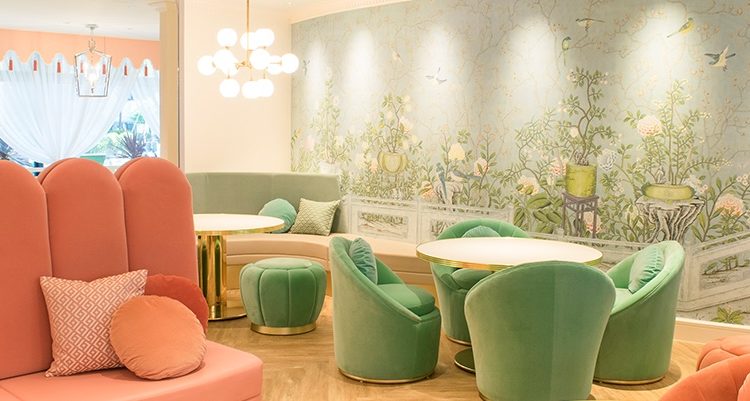 pale pink and mint green velvet armchairs and stools inside a tea room