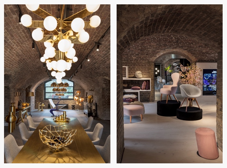 designer globe suspension lamps and upholstered furniture inside brick building