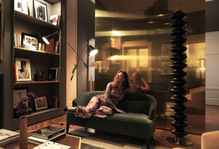 Tubes Radiatori Milano heater in black next to woman on sofa