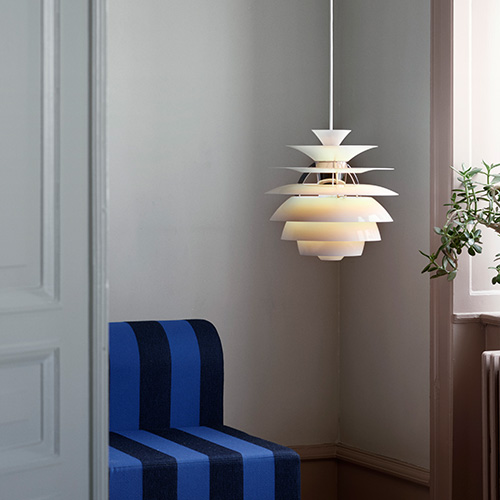 white mid-century Scandinavian suspension lamp with blue and black striped upholstered chair